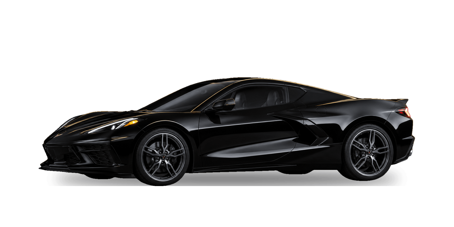 Black 2026 Chevrolet Corvette C8 Stingray mid-engine coupe under warm gold rim lighting in a dark studio.